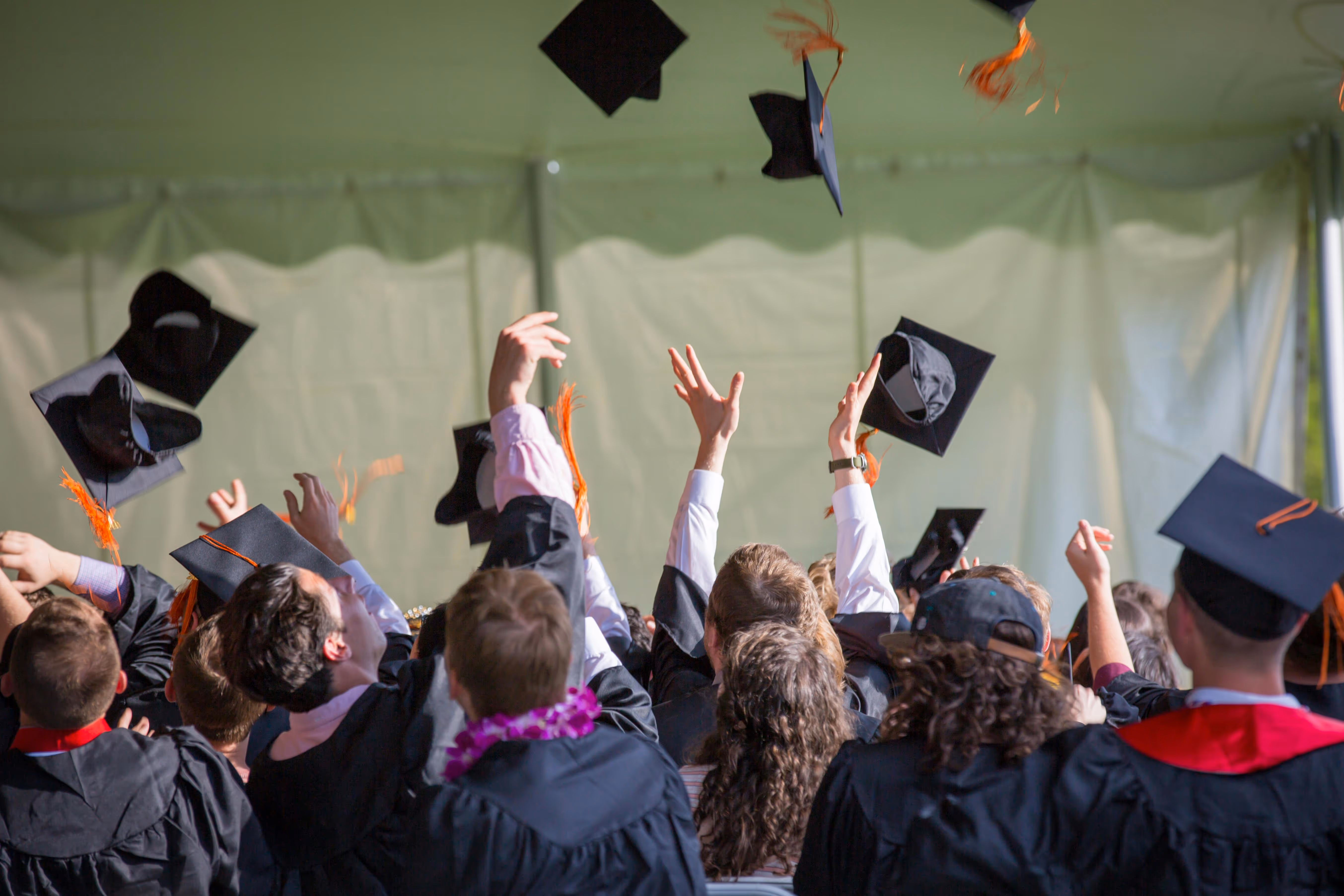Students tossing caps into the air at graduation